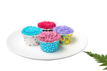 Colorful cupcakes in dish on white background