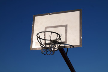 A Basketball Hoop under a blue Winter Sky