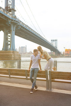 Young Couple in Love Visiting Brooklyn Bridge . New York City US