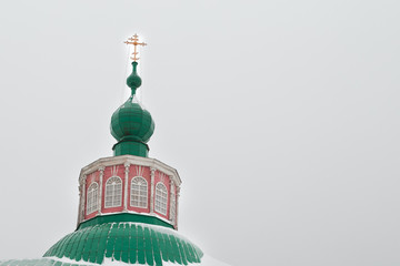 Dome of the thrown church against the background  the gray sky.