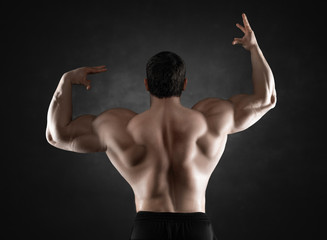 Fototapeta na wymiar Close up of sports man's muscular back isolated