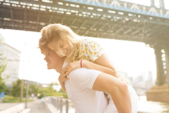 Young Couple Having Fun . Piggyback . New York City , Brooklyn 