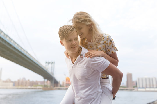 Playful Couple Under Brooklyn Bridge . New York City