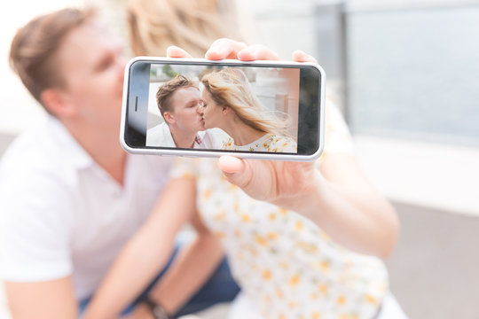 Young Beautiful Couple Taking a Picture with Phone. New York