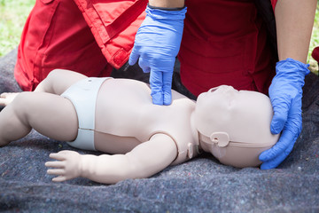 Baby CPR dummy first aid training. Heart massage. - obrazy, fototapety, plakaty