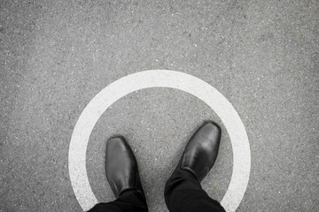 Black shoes standing in white circle