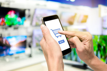 One using smartphone to buy television