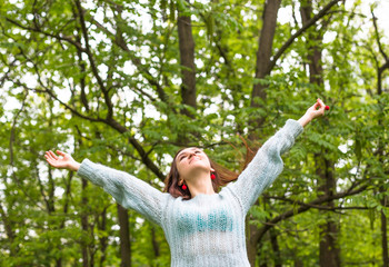 Young teenage woman relax in beautiful spring park