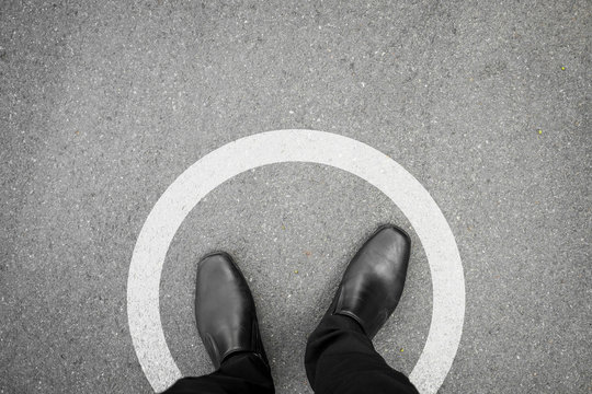 Black shoes standing in white circle