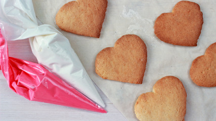 heart shaped cookies ready for decoration with pastry bags