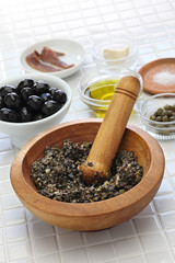 making tapenade, french black olive paste