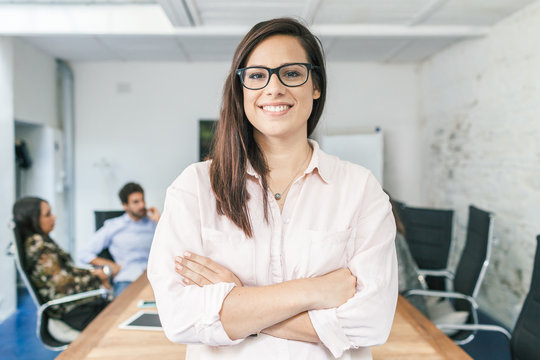 Young businesswoman looking the camera and smiling during a meeting work in office