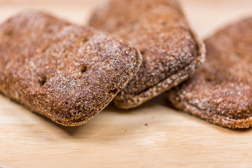 Three Pieces Of Bread On Wooden Background