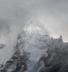The slope of the Nuptse (7864 m) into mist (view from Kala Patthar) - Everest region, Nepal,...