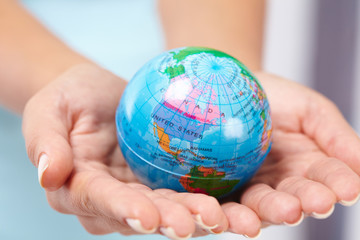 woman's hand with globe