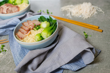 delicious egg noodle with red pork and vegetable in bowl decorat