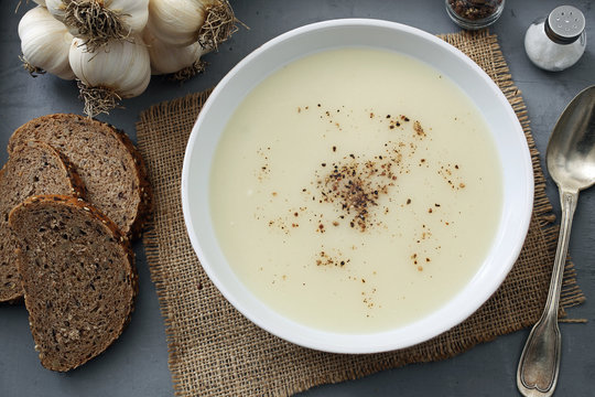 zuppa crema di aglio sfondo tavolo di cucina rustico