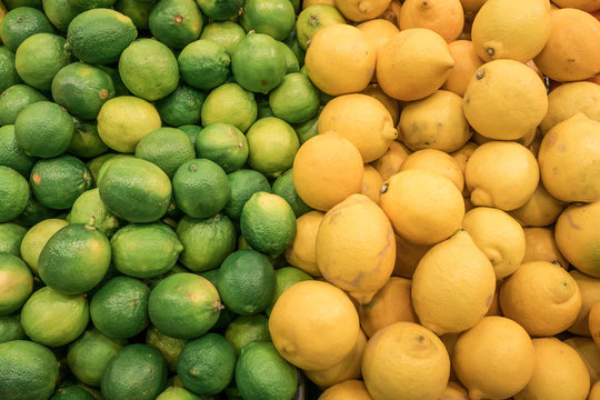 Counter with fresh citrus fruits from a market,  lime and lemons, very colorful and vibrant.