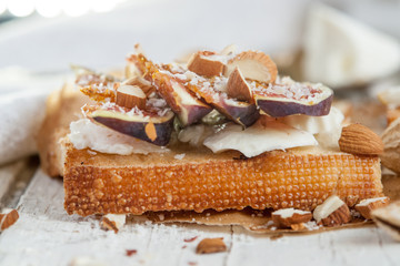 Bruschetta with goat cheese and figs on list of parchment