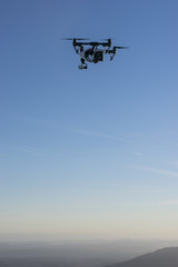 Fototapeta na wymiar A drone flying high in the sky.