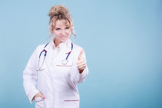 Female doctor showing thumb up.