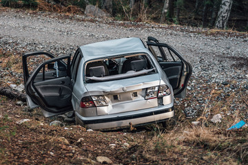 Silver colored stolen car that have been crashed and ditched on the side of a dirt road. Totally...