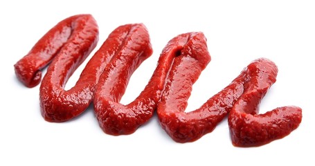 Tomatoes paste isolated closeup.