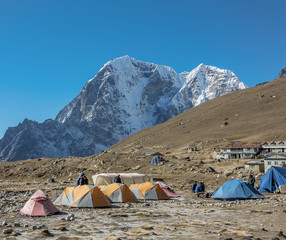 Tourist tents on the trek at the foot of mount Everest (8848 m) near Lobuche village - Nepal,...