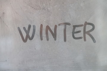 Word winter written on glass