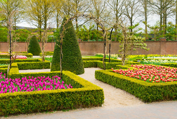Colourful Flowerbeds and Trees in an Spring Formal Garden