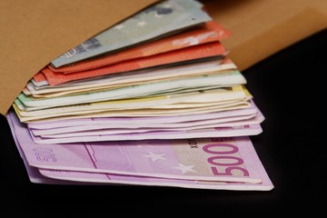 Euro banknotes in a large envelope