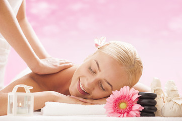 Fototapeta na wymiar Young attractive woman getting massaging treatment 