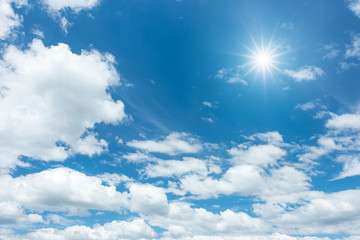 Naklejka na ściany i meble Blue sky with clouds and sun reflection