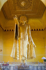 Gold sculpture of Buddha pointing