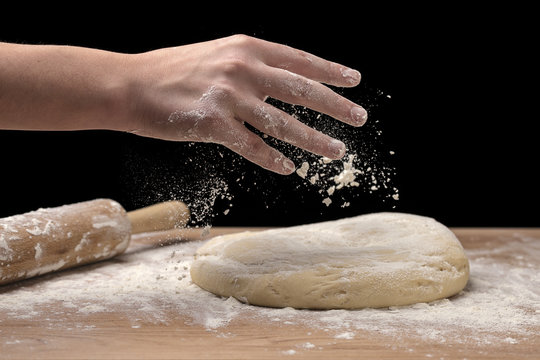 Sprinkling some flour on dough.