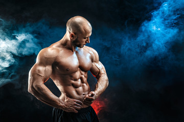 Strong bald bodybuilder with six pack. Bodybuilder man with perfect abs, shoulders,biceps, triceps...