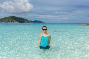 Woman standing in the turquoise water