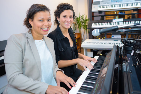 Two women at organ keyboard