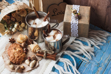 Metal mugs with cacao and marshmallows
