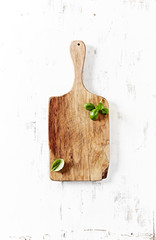 Olive wood chopping board with basil leaves