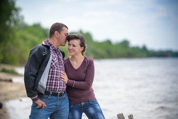 Loving young couple walk on the park at summer.