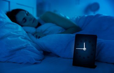 Girl peacefully sleeping in bed at night