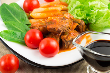 View close-up on a meal of beef stew with pasta penne,