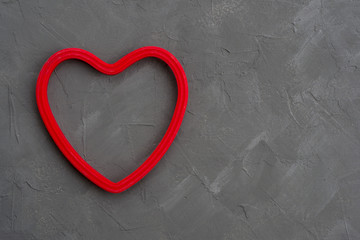 Red heart on grey concrete background