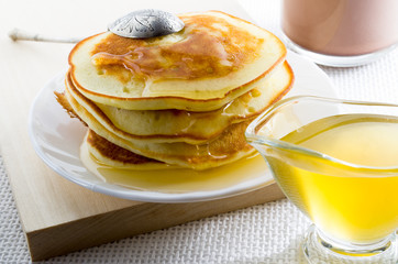 Pancakes with honey and vintage silver spoon