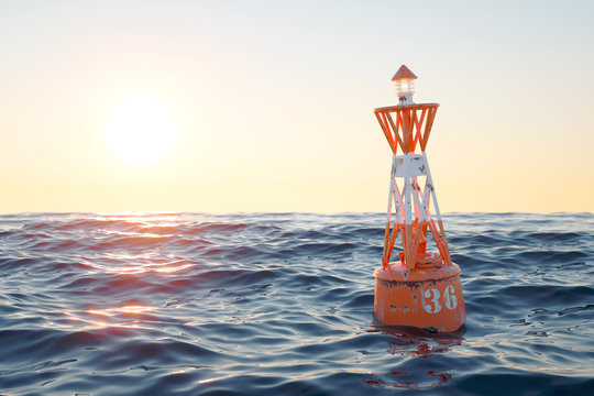 Buoy in the open sea on the sunset background.