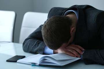 Businessman asleep at his desk in the office