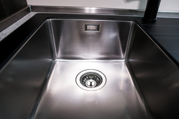 Angle view of kitchen sink with gold faucet