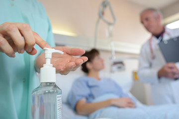 Medical worker applying hand sanitizer