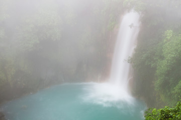 Rio celeste waterfall at foggy day